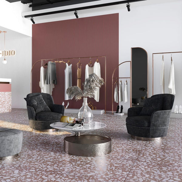 a retail store with black chairs and pink and white terrazzo tiles flooring and concave purple porcelain tiles on a feature wall.