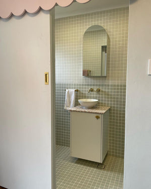 bathroom renovation with light square green porcelain mosaic and a touch of pink