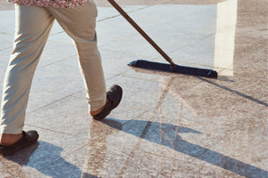 man cleaning stone on the floor