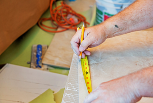 tiler measuring tiles for installation