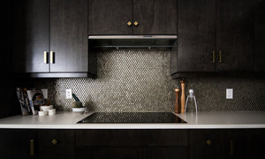 dark kitchen design with black stone mosaic splashback