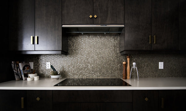 dark kitchen design with black stone mosaic splashback