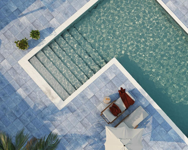 top view of a swimming pool with blue marble paver tiles.